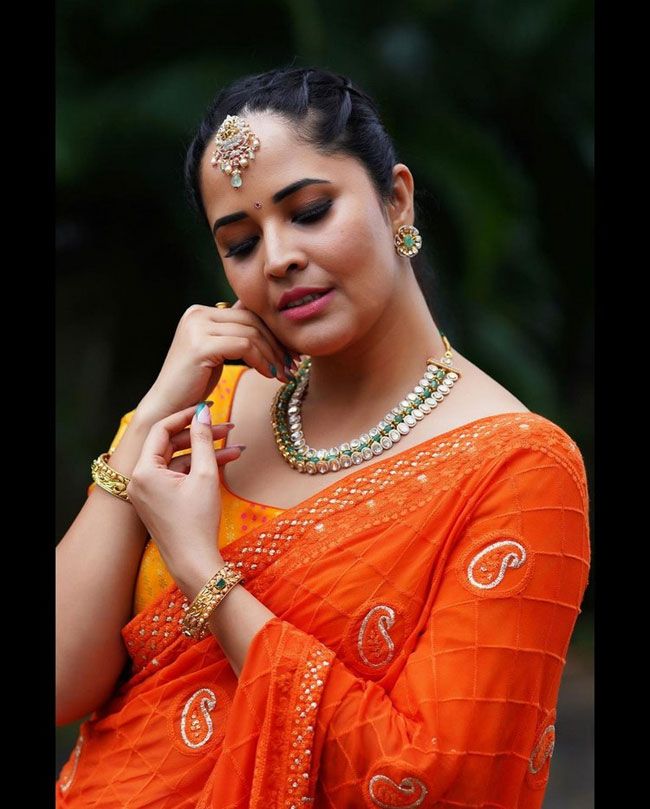 Anasuya Bhardwaj latest stills in orange color half saree
