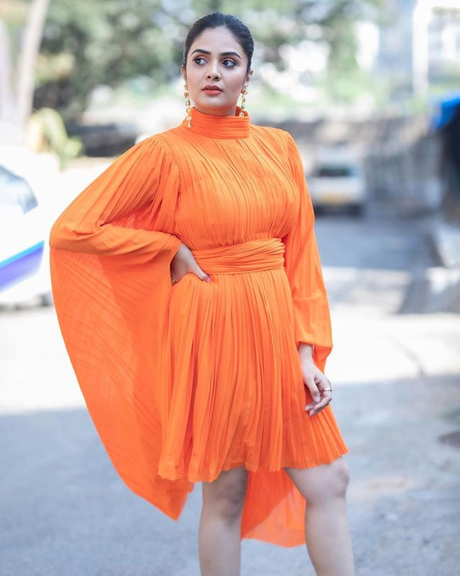 Anchor Sreemukhi stills in orange gown